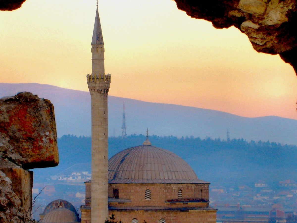 Mosque at sunset with mountains