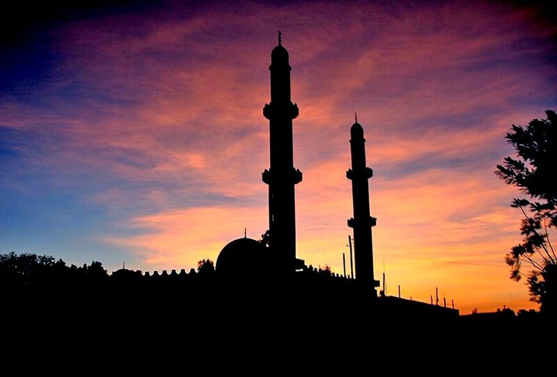 Mosque silhouetted at sunset