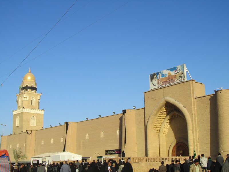 Mosque with golden dome and crowd