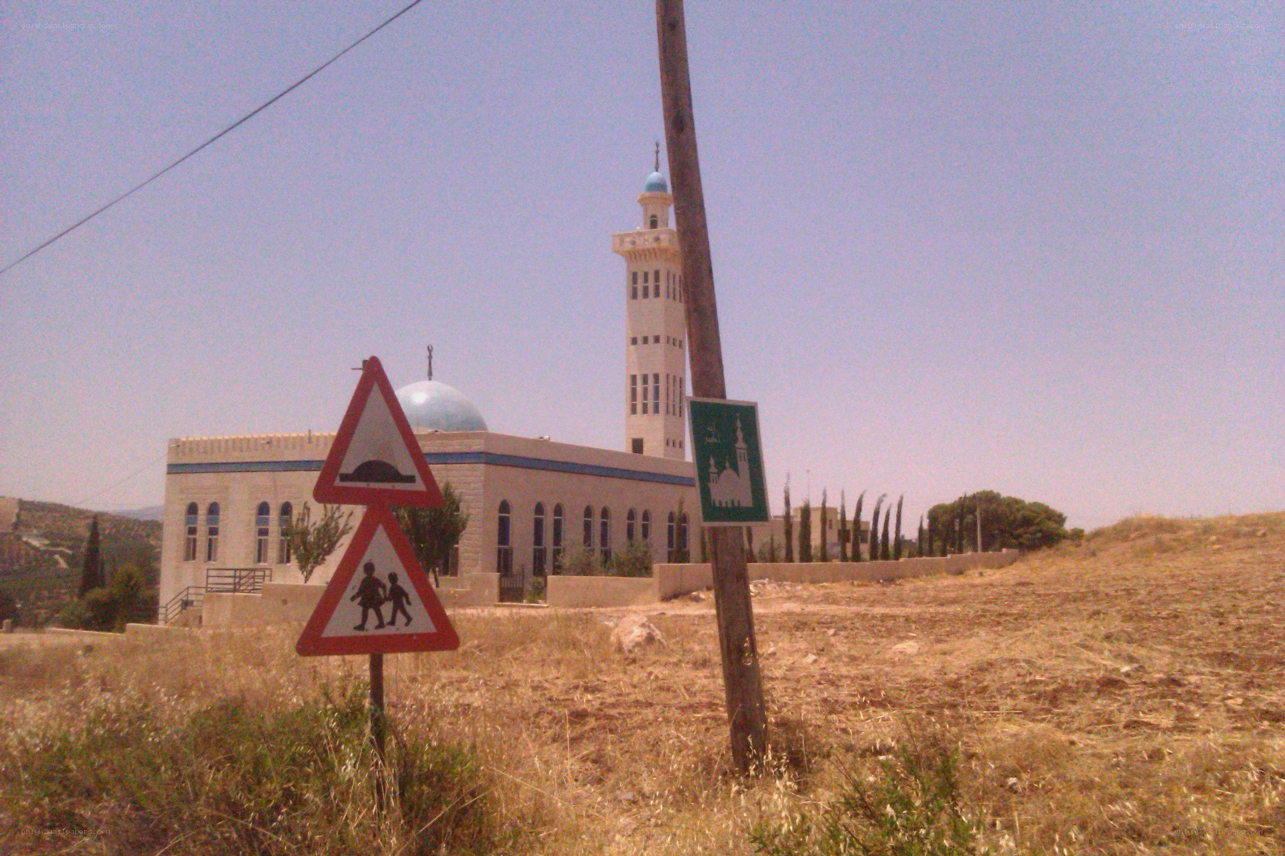 Mosque with minaret and road signs