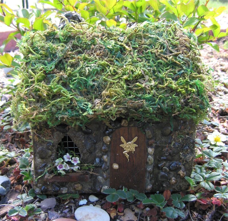 Moss-covered fairy house