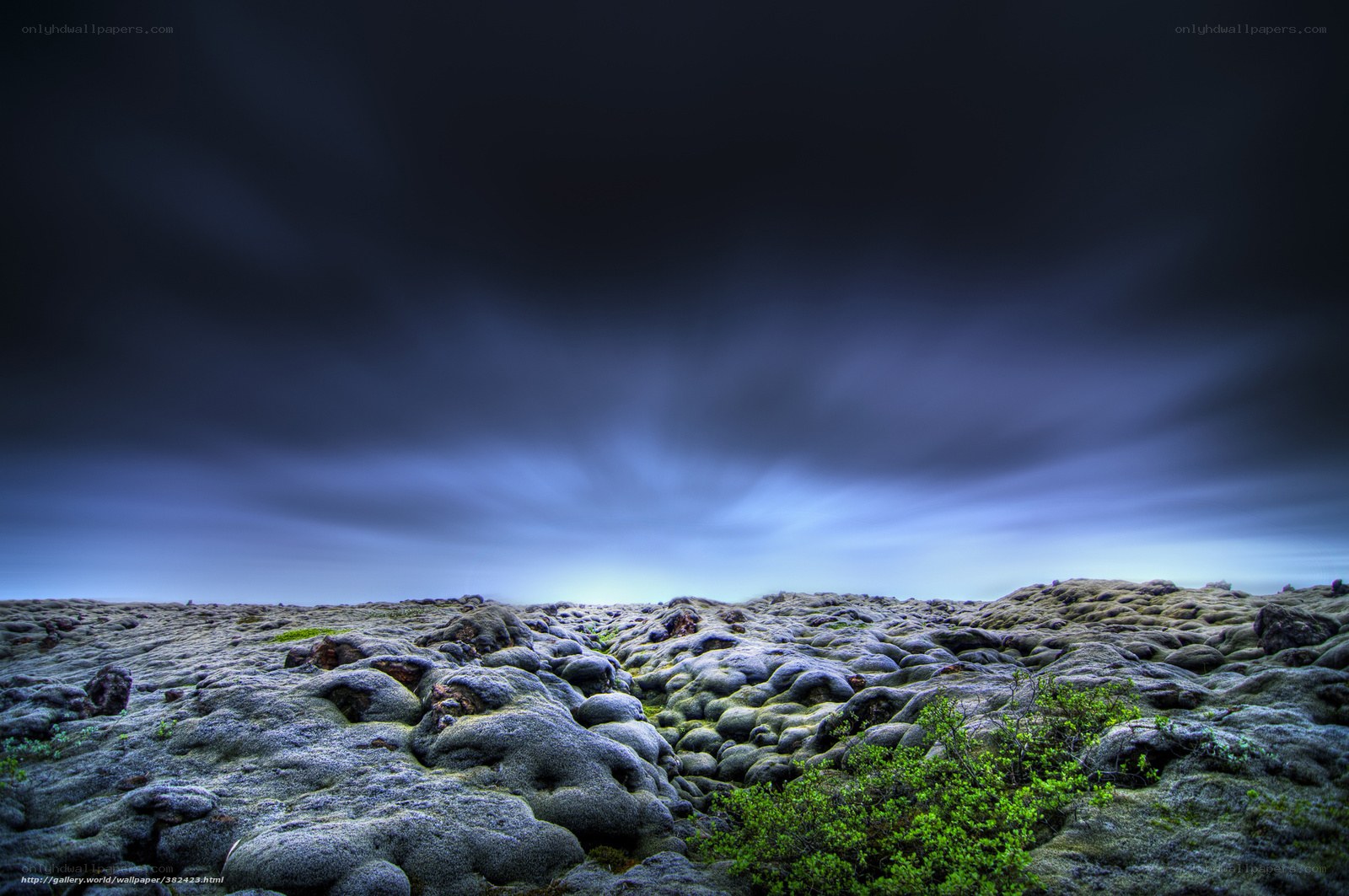 Moss-covered lava field under stormy sky