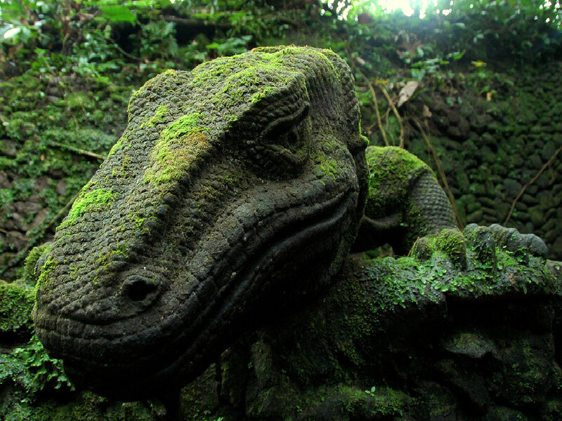 moss-covered lizard statue