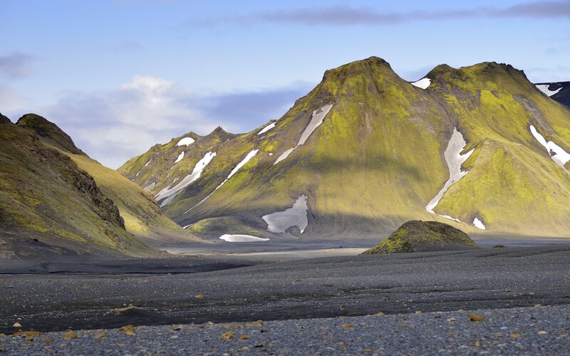 Moss-covered mountains with snow