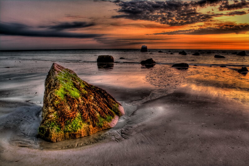 Moss-covered Rock on Beach — Orange, Dramatic