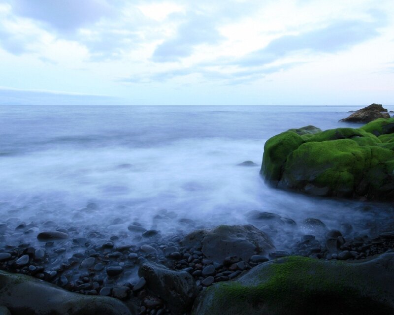 Moss-covered Rocks at Shore — Green, Serene, Sunset, Photograph, Ocean, Sky, Pebbles, Blue