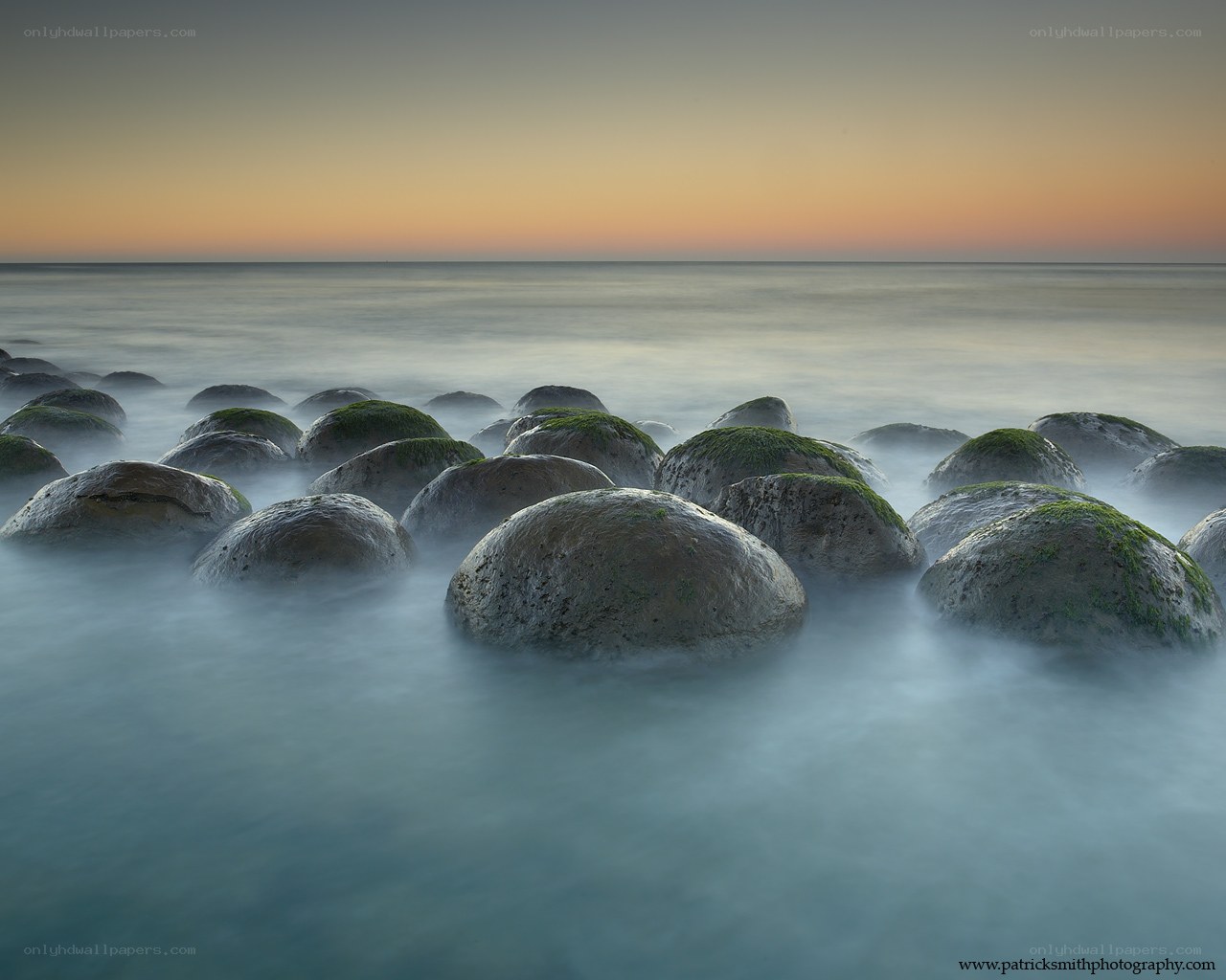 Moss-covered rocks at sunset