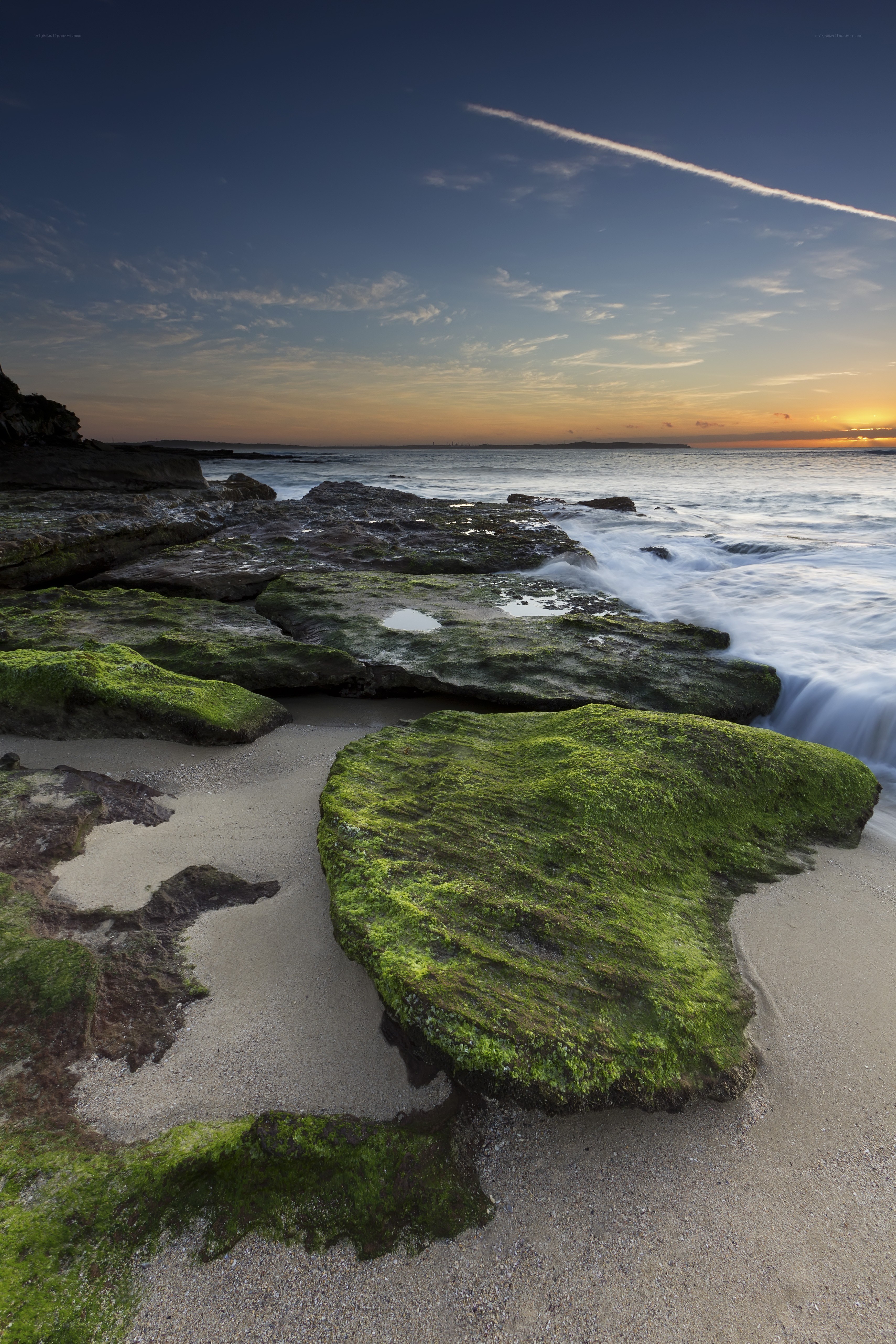 Moss-covered rocks at sunset