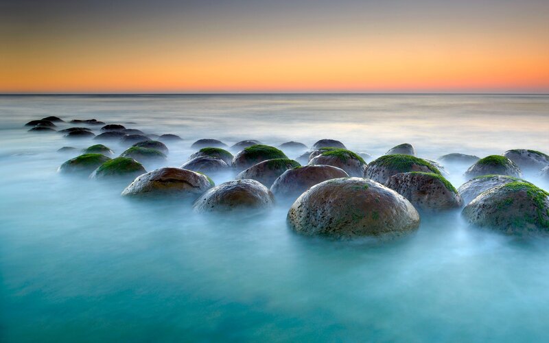 Moss-covered Rocks in Ocean — Blue