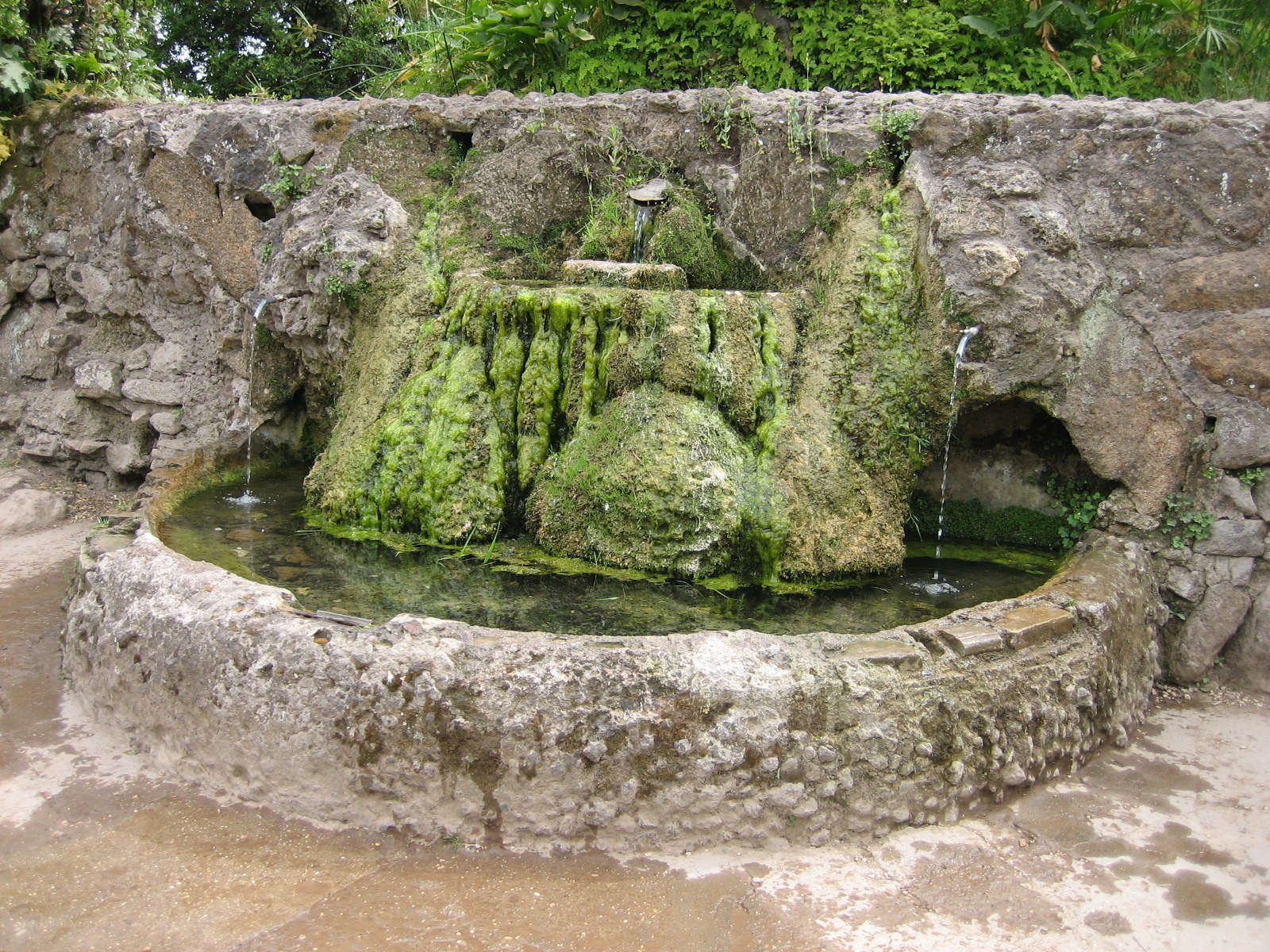 moss-covered stone fountain