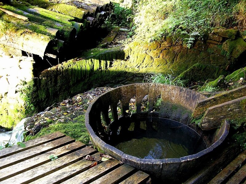 Moss-covered water wheel structure