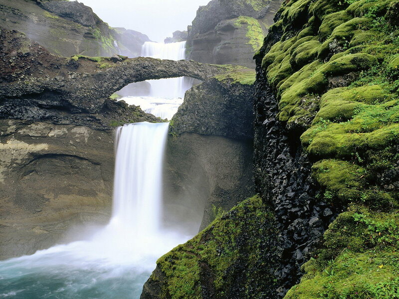 Moss-covered waterfall bridge