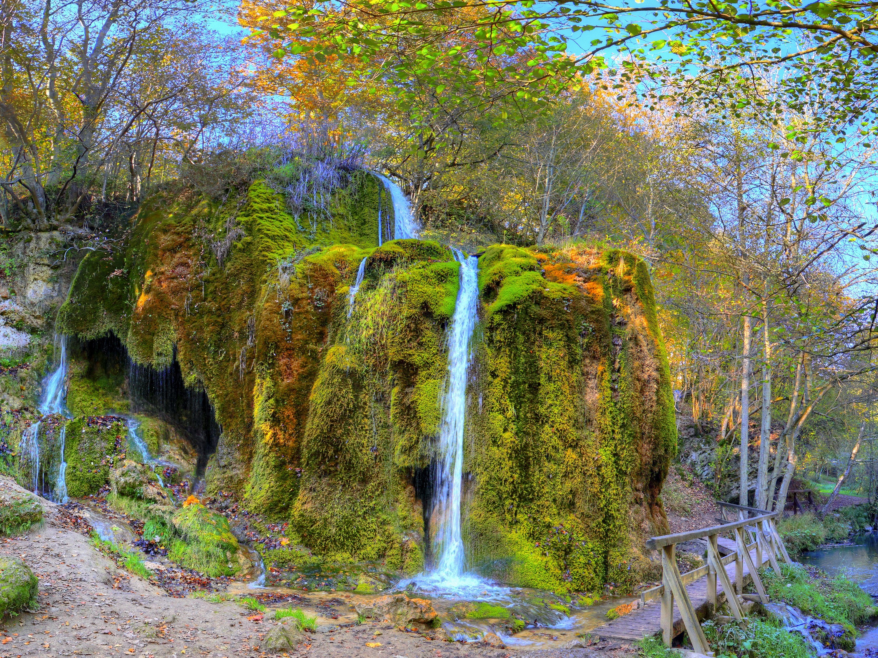 Mossy waterfall in autumn forest