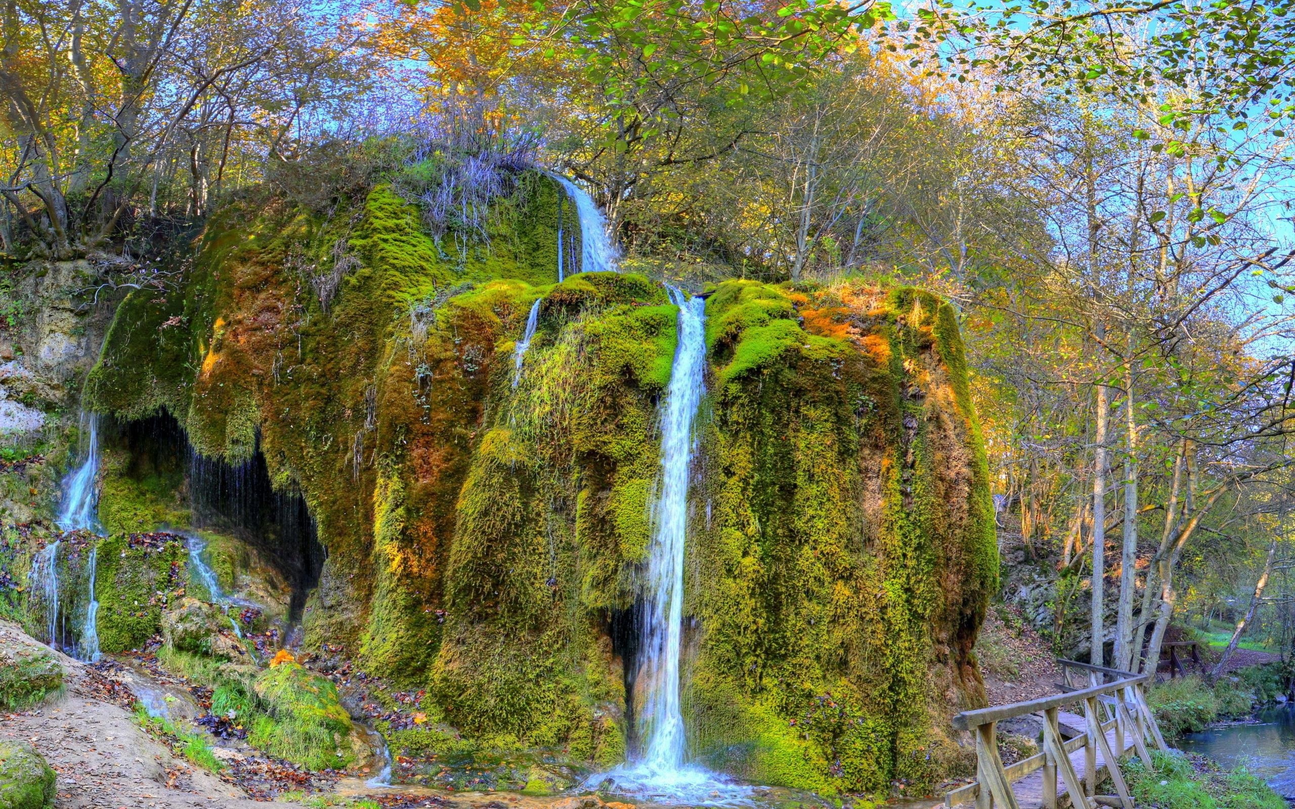 Mossy waterfall in autumn forest