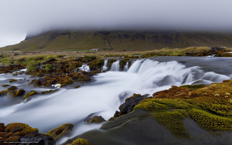 Mossy waterfall in foggy landscape