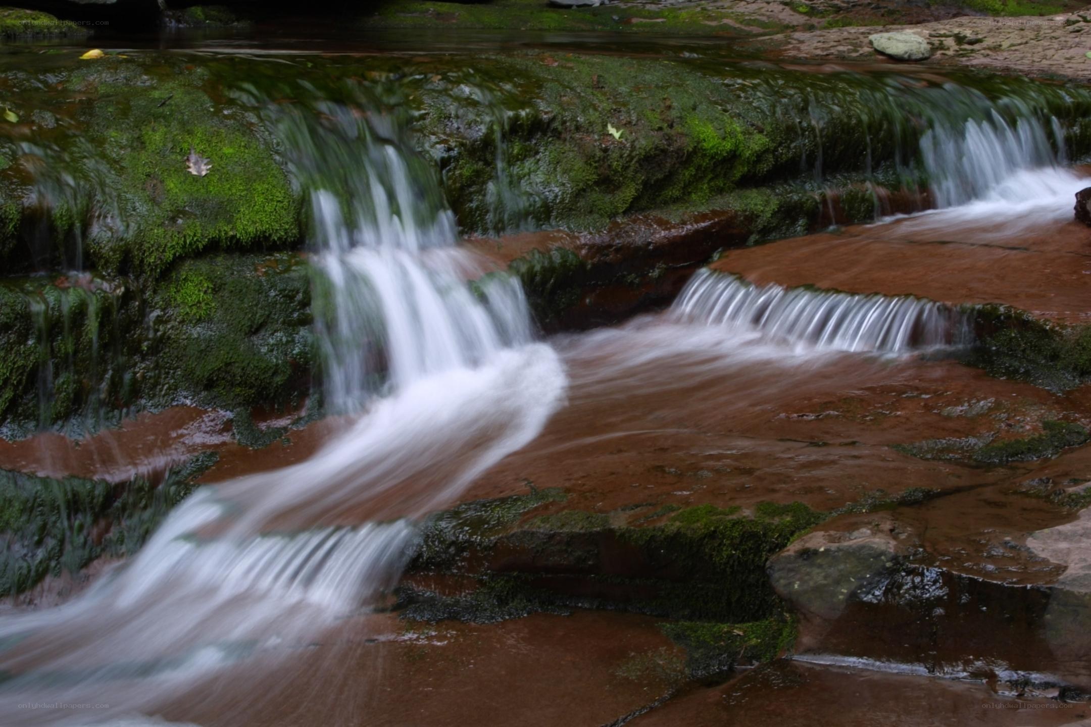 Mossy waterfall on red rock