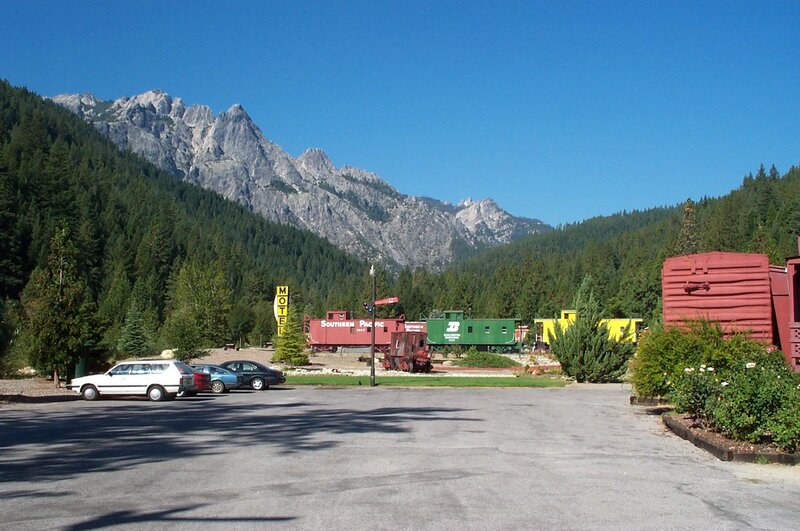Motel with train cars and mountain view