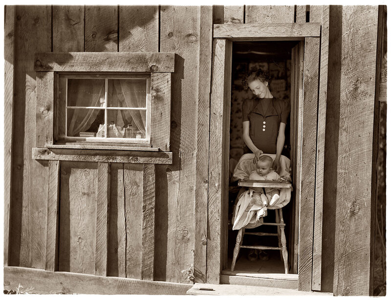 Mother and baby in a wooden cabin