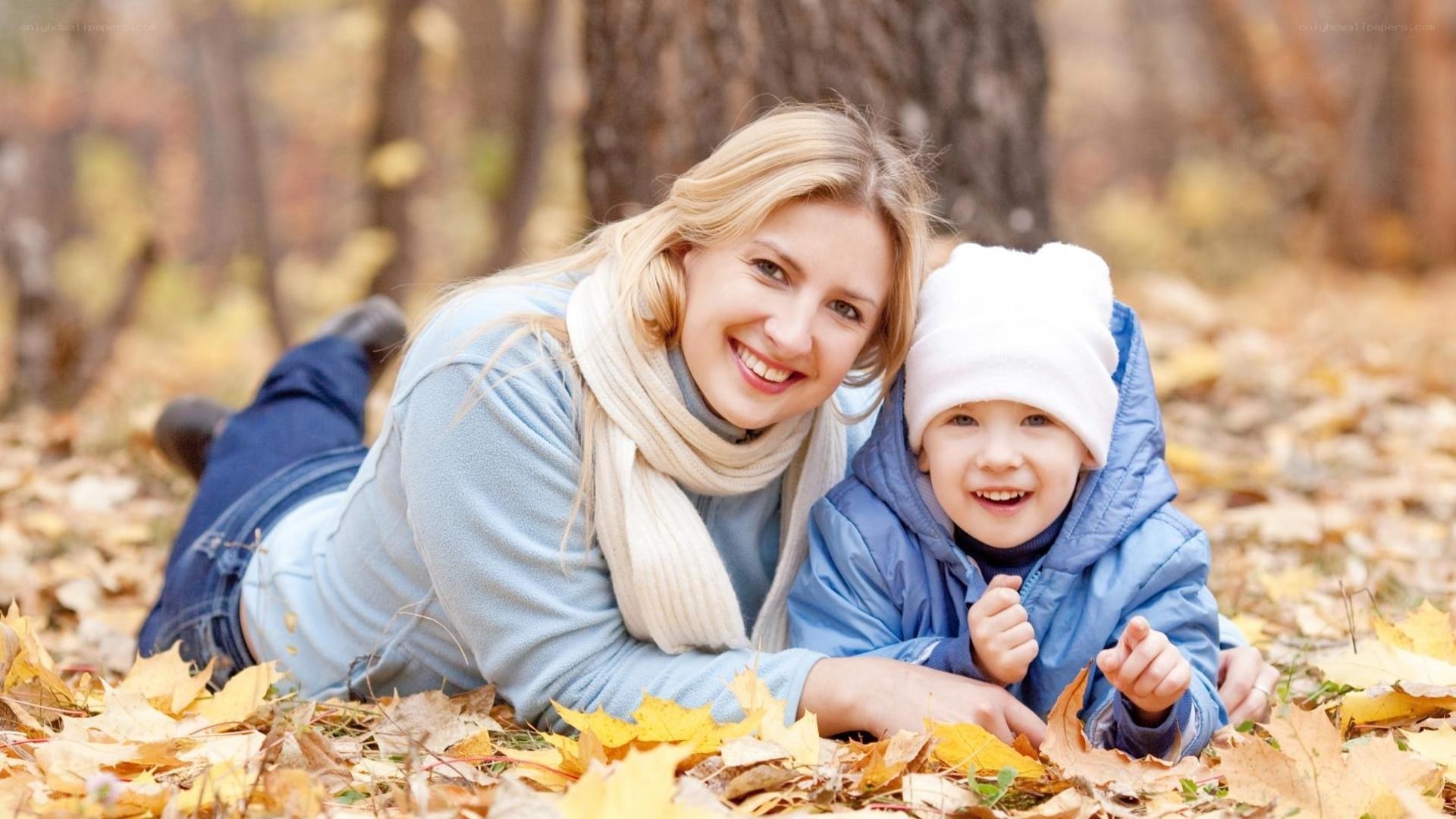 Mother and child in autumn leaves