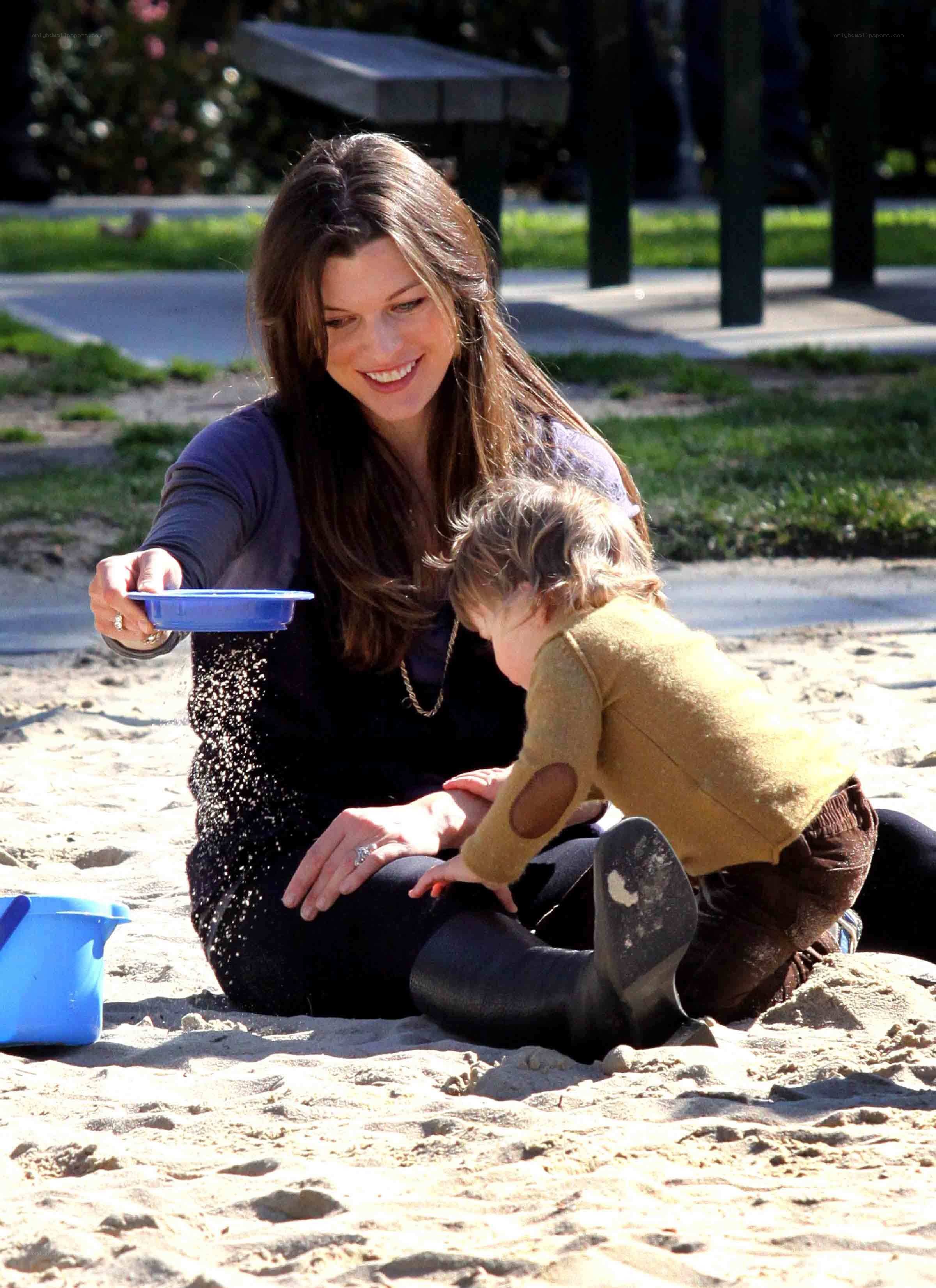 Mother and child playing in sand