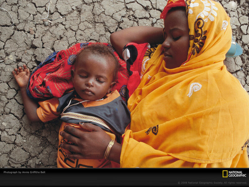 Mother and child resting on dry ground