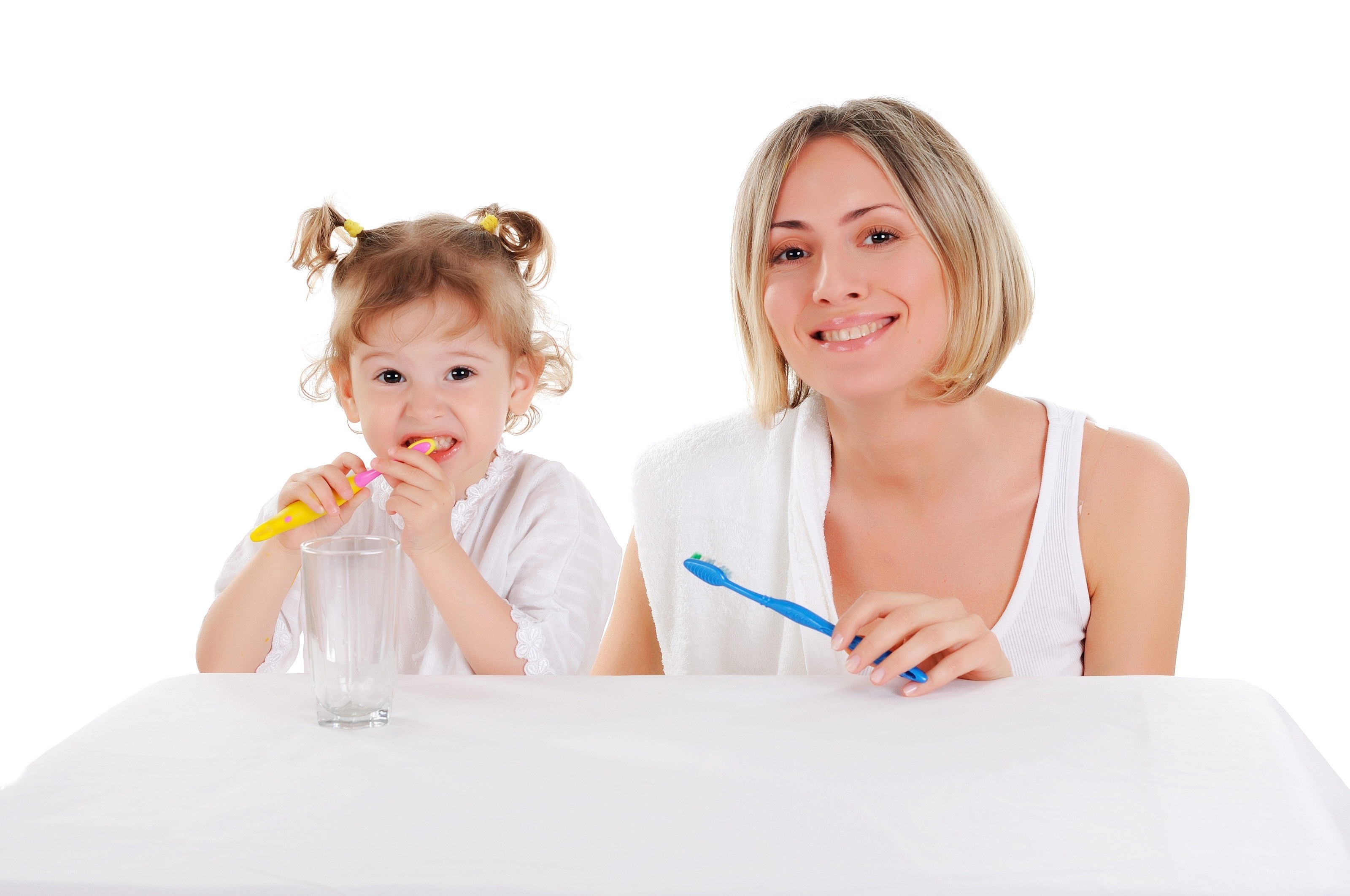 Mother and daughter brushing teeth