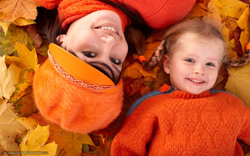 Mother and daughter in autumn leaves