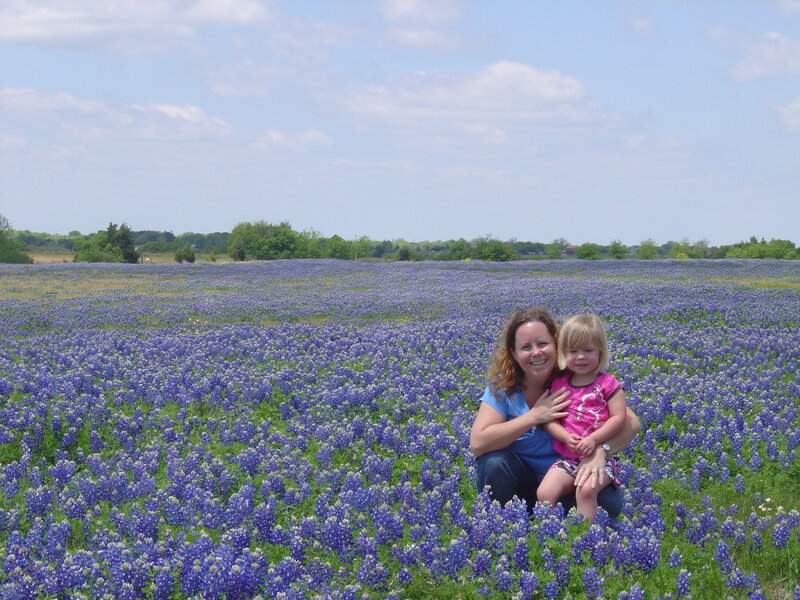 Mother and daughter in bluebonnet field