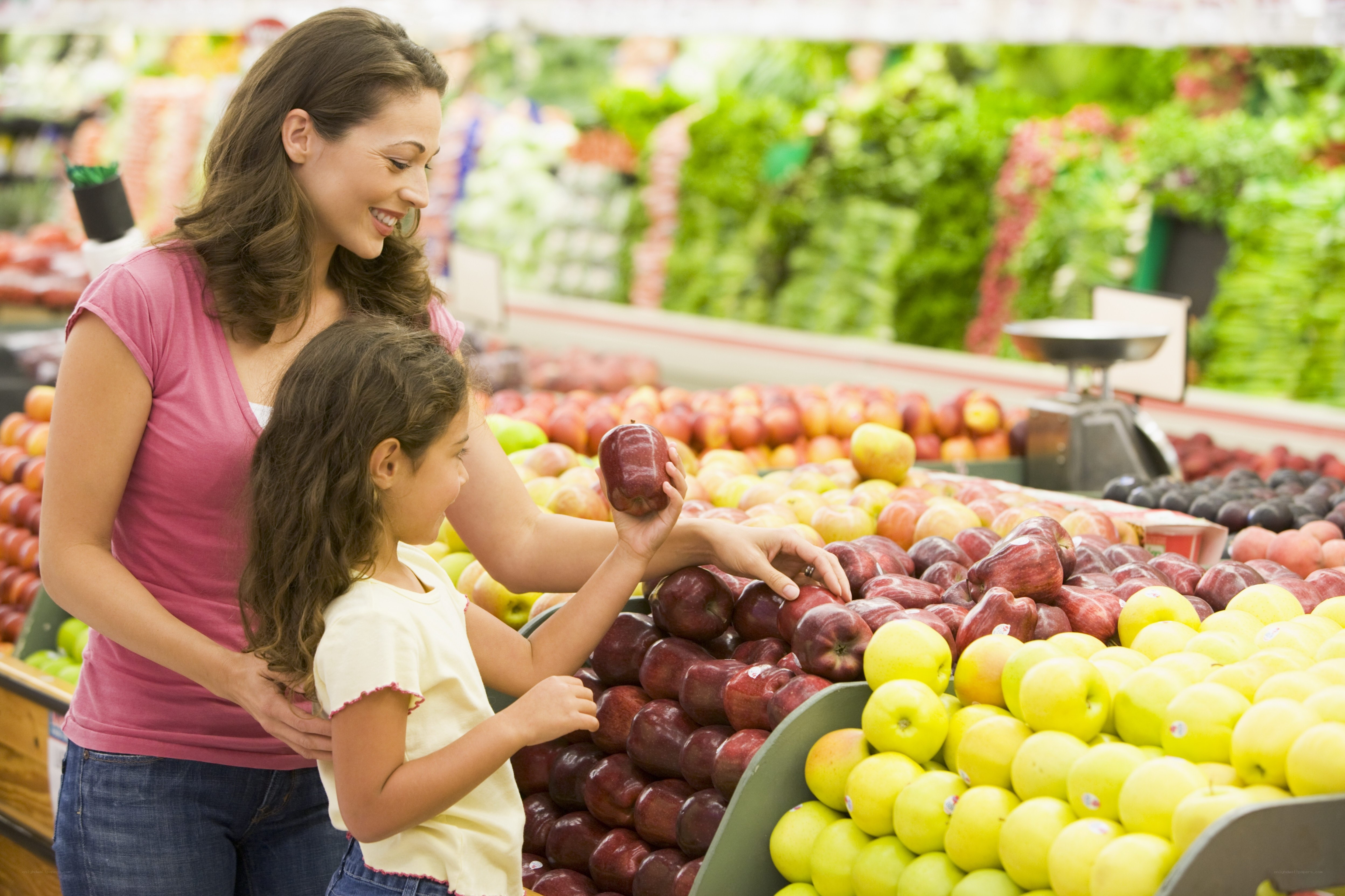 Mother and daughter picking apples