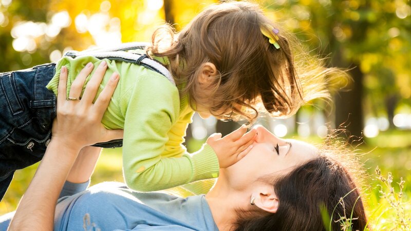 Mother and daughter playing outdoors
