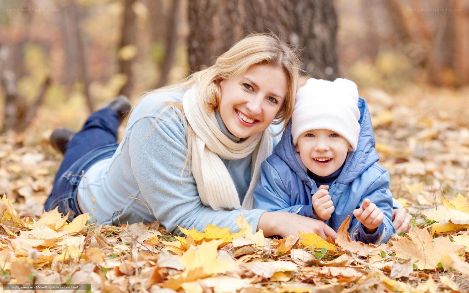 Mother and son in autumn leaves