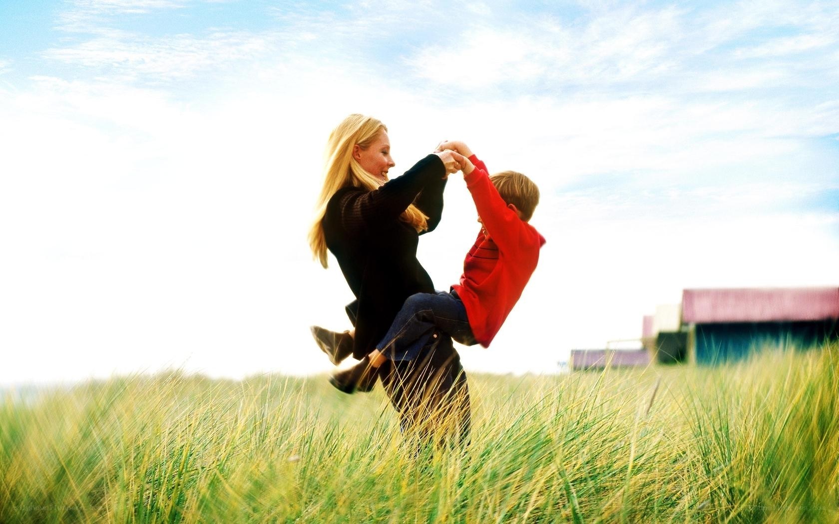 Mother and son playing in a field