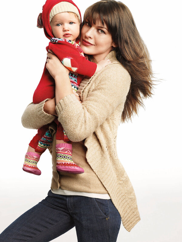 Mother holding baby in winter clothes