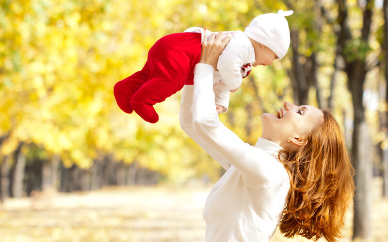 Mother Holding Baby — Yellow, Joyful