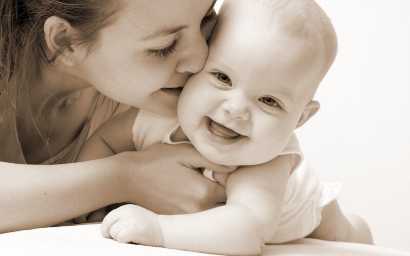 Mother kissing baby