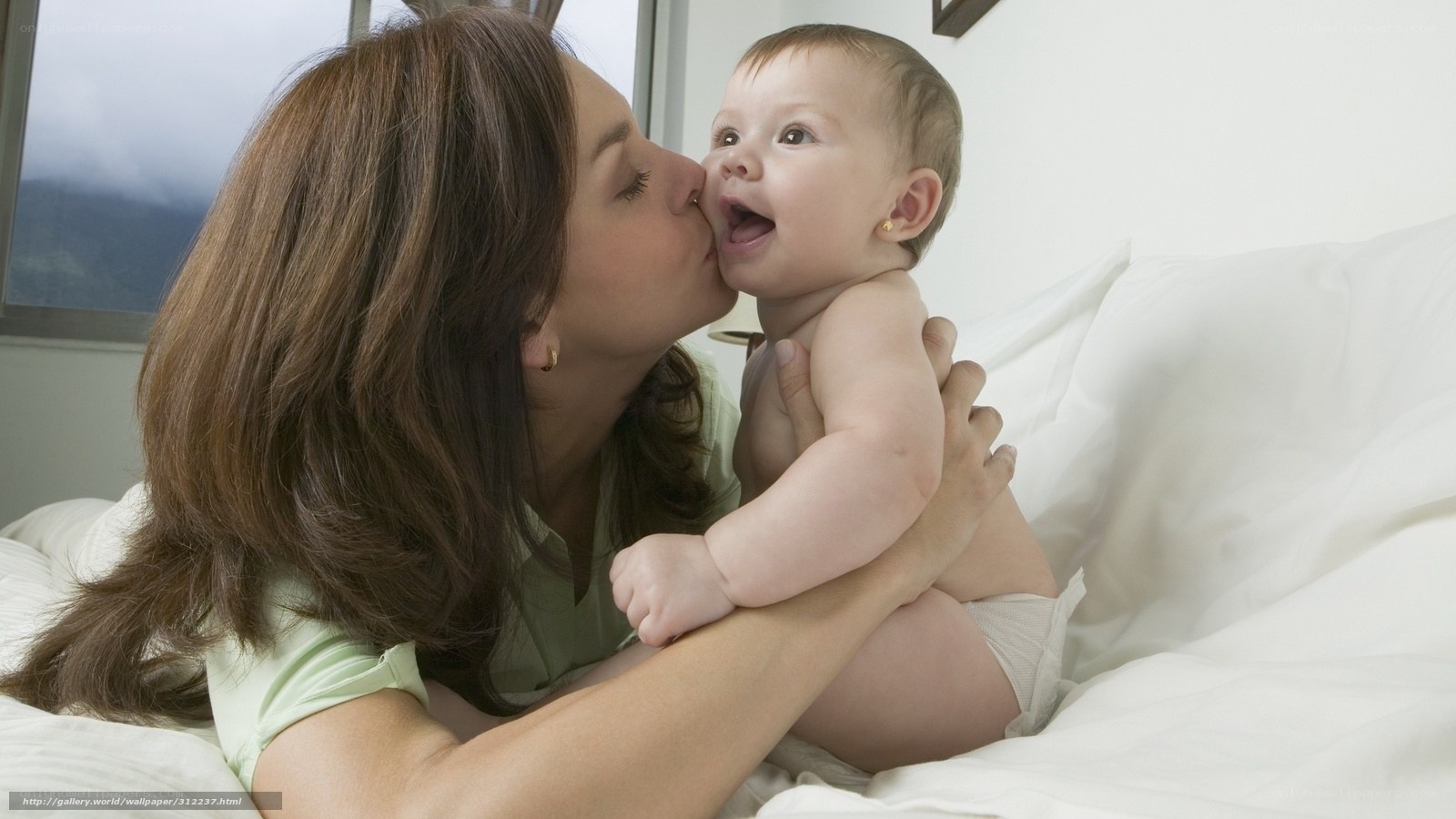 Mother kissing baby on cheek