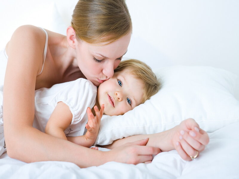Mother Kissing Child