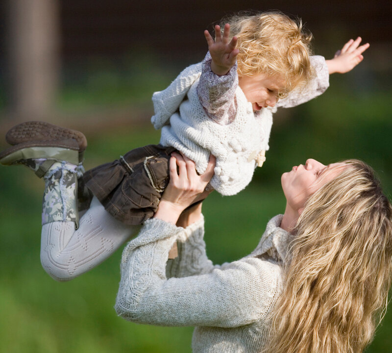 Mother Lifting Child