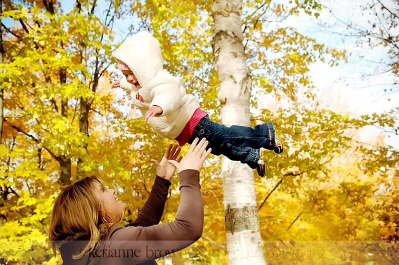 Mother playing with child in autumn