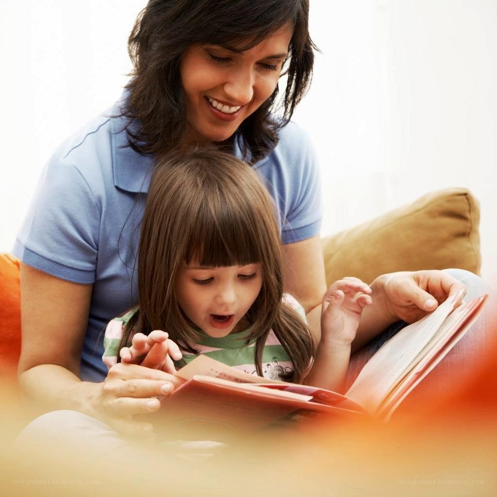 Mother reading to daughter