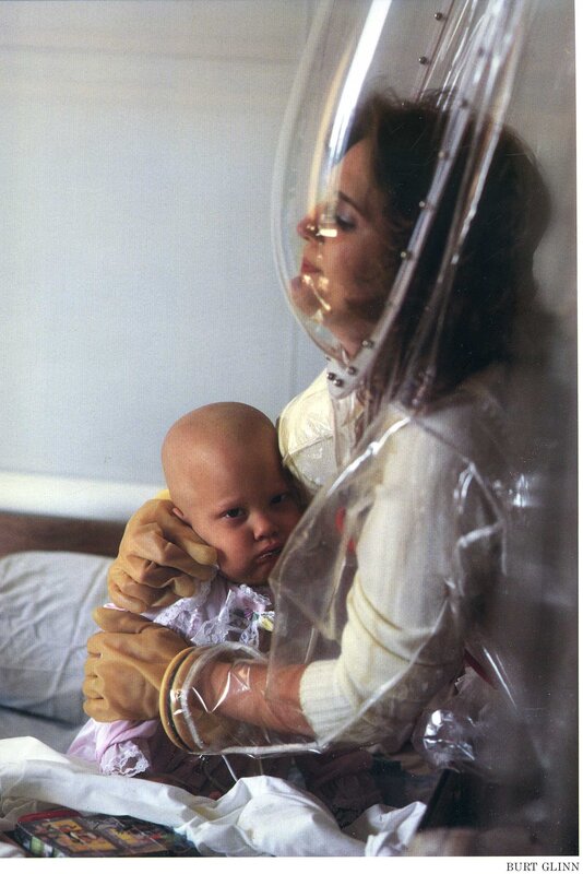 Mother with baby in isolation suit