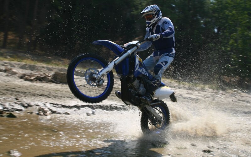 Motocross rider in muddy terrain