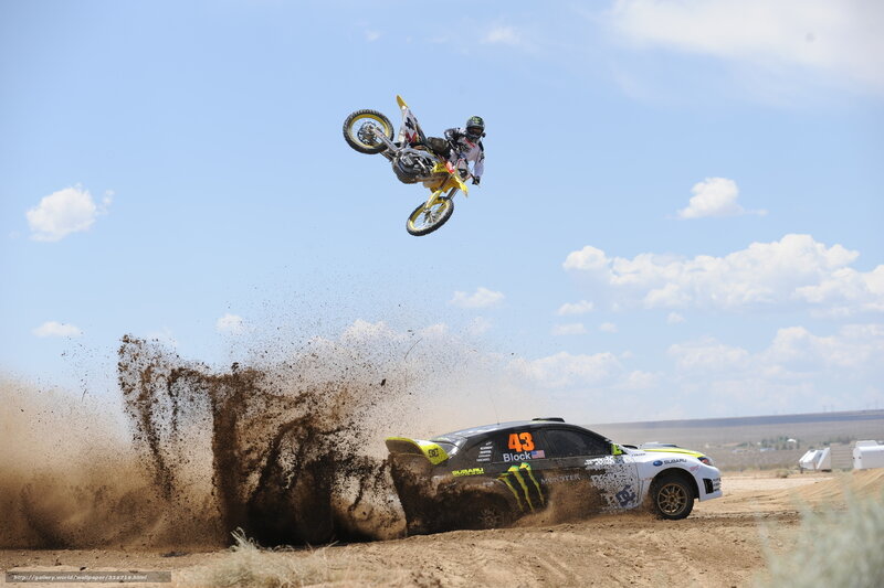 Motocross rider jumps over rally car
