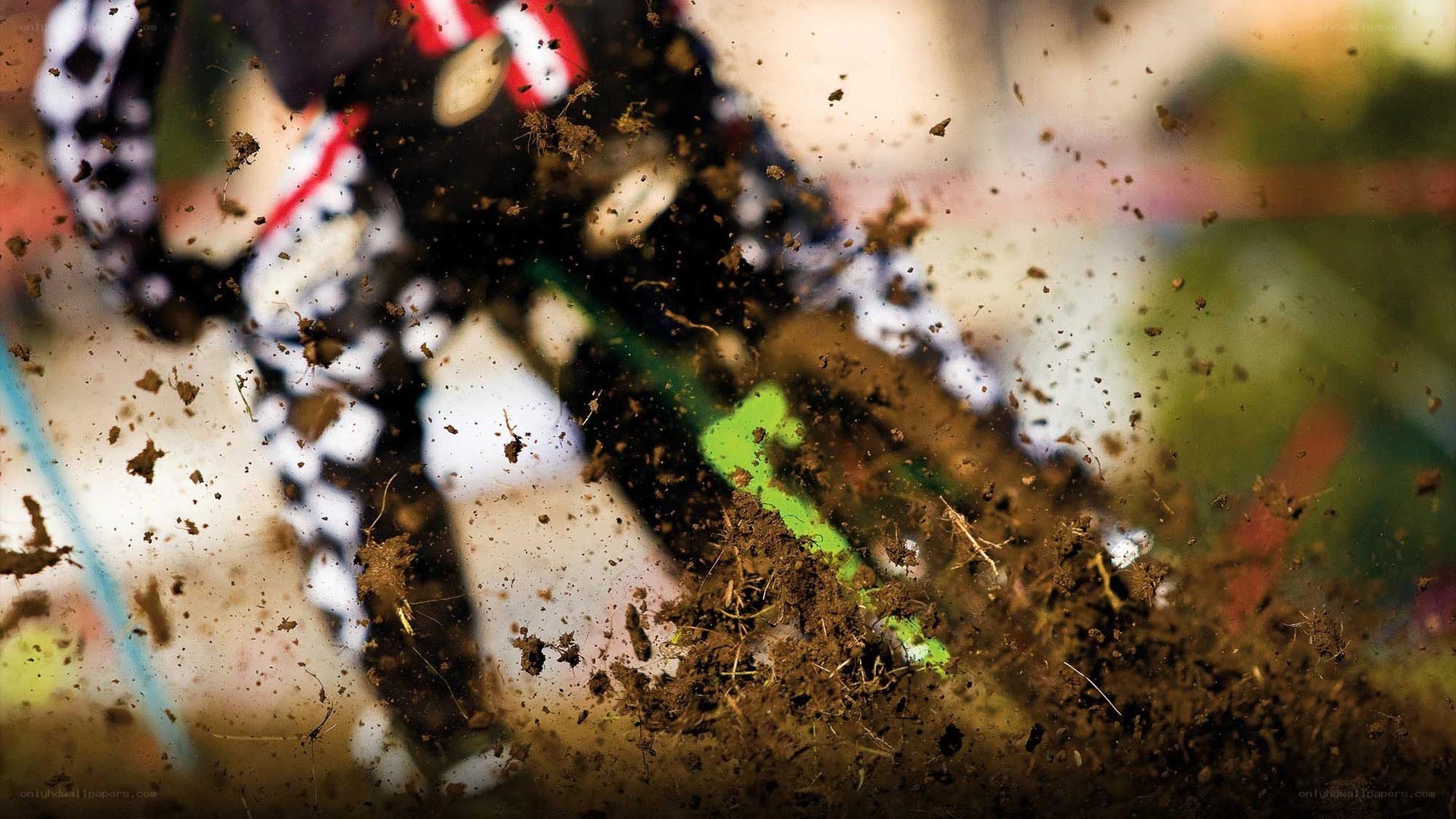 Motocross rider kicking up mud