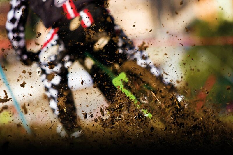 Motocross rider kicking up mud
