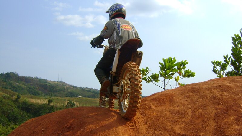 Motocross rider on dirt hill