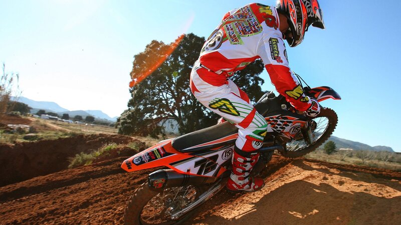 Motocross rider on dirt track
