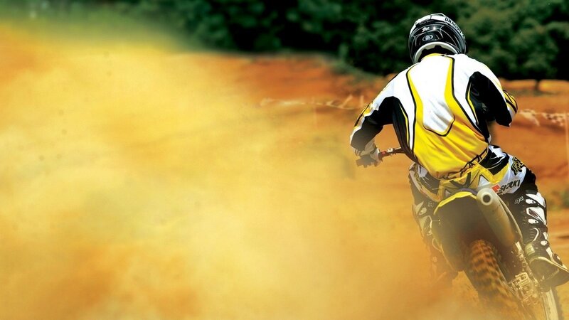 Motocross rider on dirt track