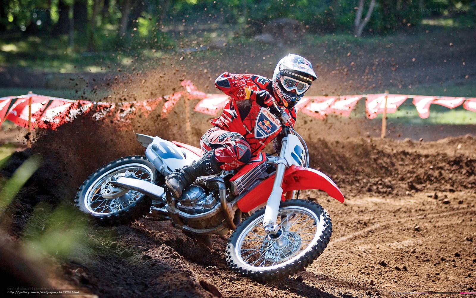 Motocross rider on dirt track