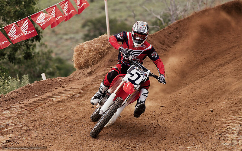 Motocross rider on dirt track